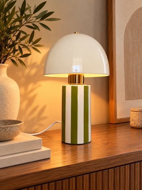 Lampe champignon kaki en céramique installée dans un intérieur chaleureux, sur une console en bois.